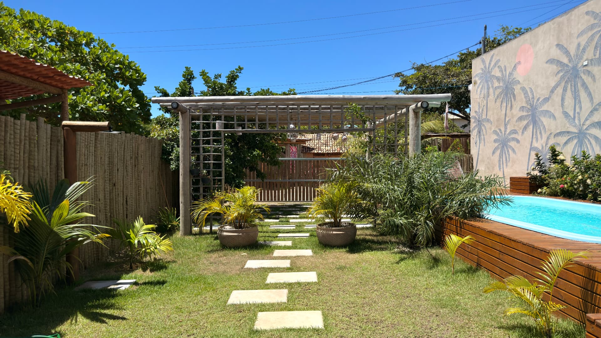 Pergolado de madeira entre as plantas do jardim